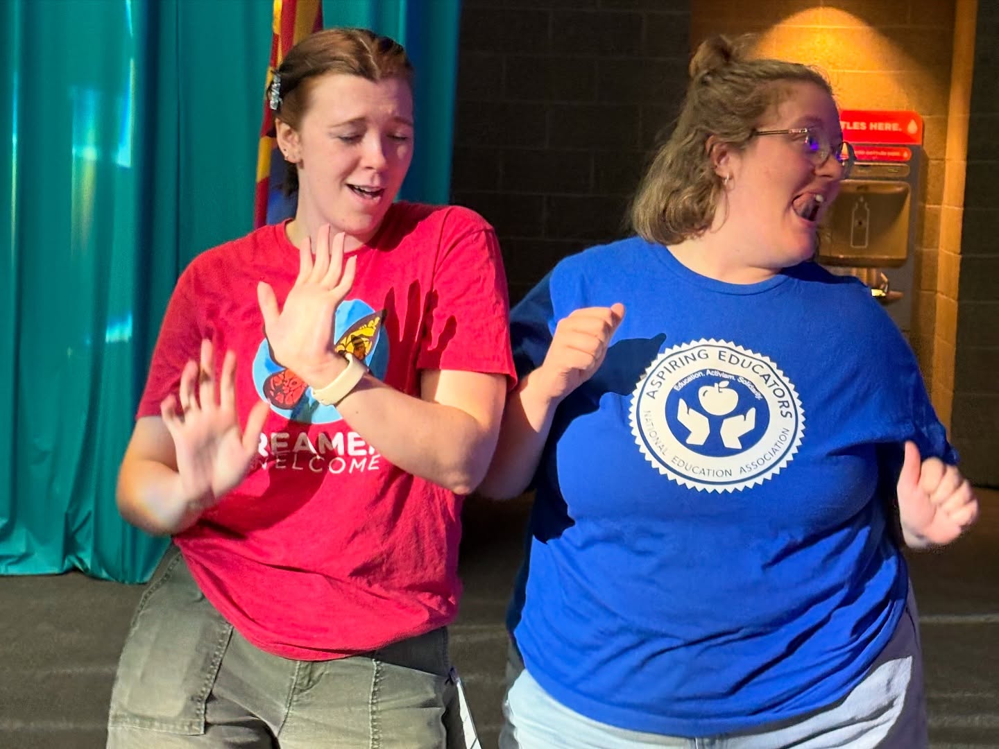 Hannah Dancing at an NEA Conference wearing a red shirt. 