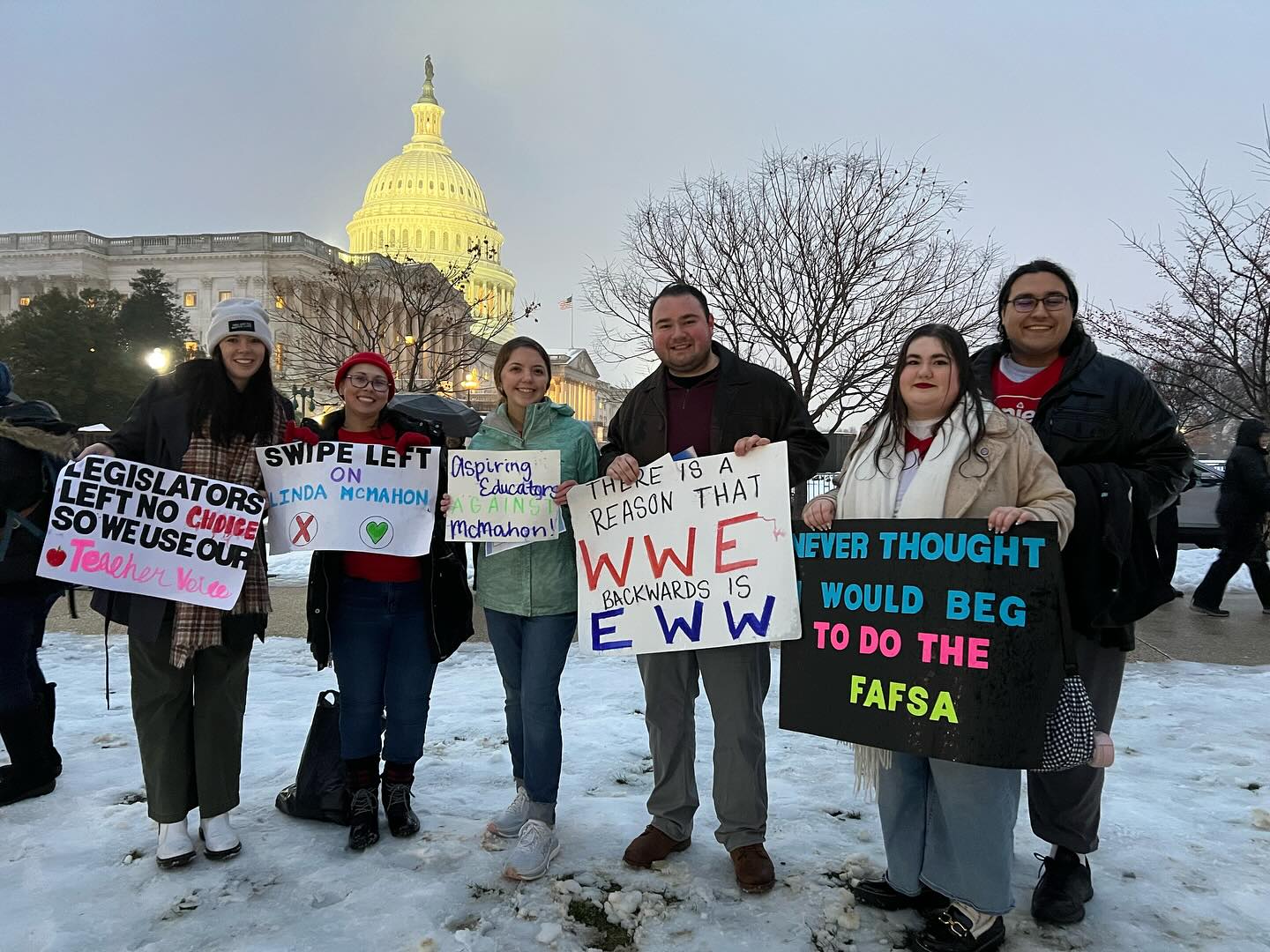 Hannah standing in front of U.S. Capital holding up a protest sign. 